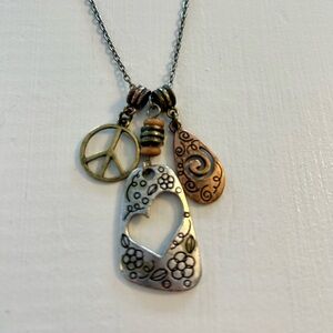 Lia Sophia peace and love necklace. Like new. Silver, and brass tones.